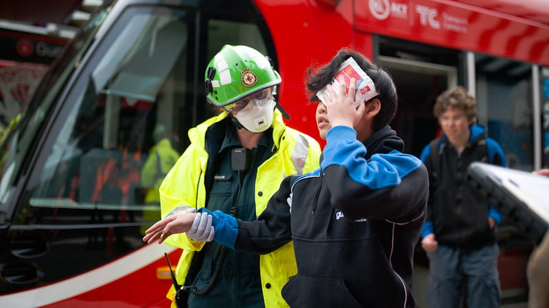 Gungahlin College student is led from the incident site by ACT Ambulance Service Paramedic